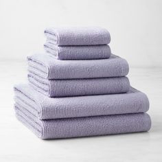 six lavender towels stacked on top of each other