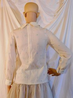 "No tags, I believe this top is hand made My cousin turtle neck, back zipper and snap cuff sleeves. Pretty pale florals in pink and blue Material is a cotton blend Best for size xs-small Measurements are approximate and taken laying flat 16\" chest armpit to armpit 12\" shoulder width 15\" waist 12\" zipper Excellent vintage condition no rips tears or stains" Spring Cotton Crew Neck Blouse, Spring Cotton Blouse With Crew Neck, Cream Peter Pan Collar Blouse For Spring, Cream Floral Print Top For Daywear, Long Sleeve Cotton Top For Daywear, Cotton Long Sleeve Top For Daywear, Long Sleeve Cotton Top With Floral Print, Spring Fitted Collared Top, Feminine Fitted Collared Top