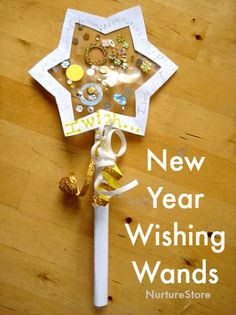 a new year's wish wand made out of paper and other items on a wooden table