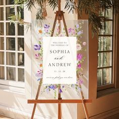 an easel with a sign that says welcome to the wedding of sophiia and andrew