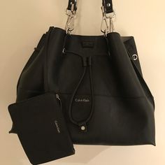 Calvin Klein Unlined Black Drawstring Tote Bag With Magnet Closure And Bonus Removable Makeup Bag, Silver Hardware, Unused, No Marks Or Scratches, Like New Condition! Black Leather Calvin Klein Bag, Calvin Klein Black Shoulder Bag For Daily Use, Calvin Klein Black Shoulder Bag With Removable Pouch, Calvin Klein Black Shoulder Bag For Shopping, Modern Calvin Klein Black Bag, Modern Black Calvin Klein Bag, Calvin Klein Black Bag For Everyday Use, Calvin Klein Black Shoulder Bag For Everyday, Black Calvin Klein Shoulder Bag For Everyday