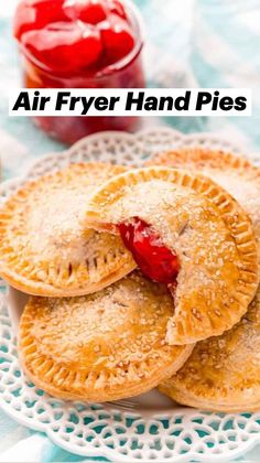 three small pies on a plate with jelly in the background