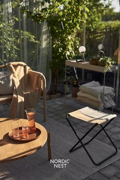 a table with two glasses on it next to a chair