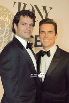 two men dressed in tuxedos posing for a photo at the tony award gala