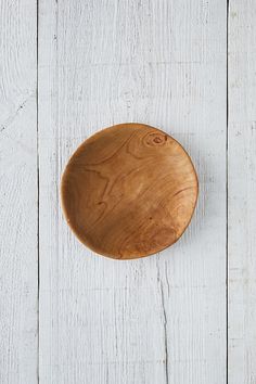 a wooden plate sitting on top of a white table