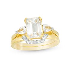 Take her breath away with this luxurious bridal set. Crafted in sterling silver with 14K gold plate, the exquisite engagement ring showcases a sparkling 8.0 x 6.0mm emerald-cut lab-created white sapphire flanked by 3.0 x 4.0mm pear-shaped created sapphires. On your wedding day, complete her look with the coordinating contoured band shimmering with petite round created sapphires. Polished to a bright shine, this bridal set is destined to be admired. Custom-made to fit her ring size. Sterling silv Zales Engagement Rings, Band Ideas, Round Sapphire, Her Ring, Peoples Jewellers, Bridal Engagement Rings, Jewelry Outfit, Sapphire Stone, Shop Engagement Rings