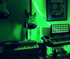 a room filled with musical instruments and green lighting in the corner, including an electric guitar