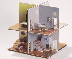 a doll house with stairs and furniture in it