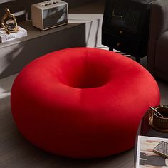 a red bean bag chair sitting on top of a wooden table