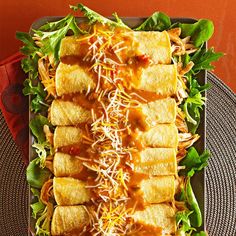 a plate topped with lots of food on top of a table