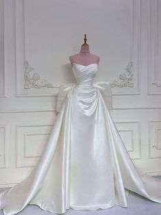 a white wedding dress on a mannequin