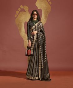 This exquisite saree is crafted from pure viscose handloom weaving silk, offering a luxurious and elegant look. The saree measures 5.5 meters in length, providing ample fabric for a traditional drape. The accompanying blouse is made from pure viscose handwoven silk and comes unstitched, allowing for a custom fit up to 42 inches. Weighing just 800 grams, this saree is lightweight and comfortable, making it perfect for any special occasion. The combination of handloom weaving and viscose silk ensures a stunning blend of tradition and modern style.

#ViscoseSilkSaree
#HandloomWeaving
#ElegantSaree
#TraditionalWear
#DesignerSaree
#FestiveFashion
#WeddingWear
#EthnicChic
#CulturalElegance
#SilkSaree
#SareeLove
#FashionInspiration
#HandwovenBlouse
#BridalFashion
#EthnicOutfit Black And Gold Saree, Black Banarasi Saree, Lehenga Choli Wedding, Bollywood Lehenga, Ethnic Chic, Ready To Wear Saree, Casual Saree, Party Kleidung, Bridal Lehenga Choli