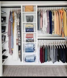 an organized closet with clothes and shoes