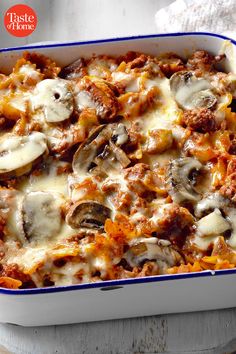 a casserole dish with meat, cheese and mushrooms in it on a table