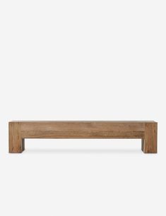 a wooden bench sitting on top of a white wall