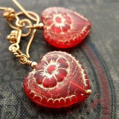 "Beautiful red glass hearts, etched in gold, hang from delicate, twisted wire loops and decorative earwires of vermeil. A lovely gift for yourself or somebody else on Valentine's Day. Length from bottom loop of earwire: 1\"(25mm) Diameter of heart: 3/4\"(20mm) All Debra Dane jewelry arrives in a pretty box suitable for gifting. These earrings are also available with non-pierced gold plated clips. They will have a gold ball instead of the ornate piece that is on the pierced earwires." Elegant Red Heart Beads Earrings, Elegant Red Heart Earrings For Gift, Dainty Handmade Red Earrings, Red Heart Beads Earrings For Gift, Valentine's Day Festive Heart-shaped Jewelry, Red Vintage Heart Earrings For Gifting, Red Vintage Heart Earrings For Gift, Vintage Red Heart Earrings For Gift, Vintage Red Heart Earrings As Gift