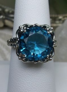 Excited to share the latest addition to my #etsy shop: 6ct Sim Swiss Blue Topaz Gem Sterling Silver Floral Bow Victorian Filigree Ring Size {Made To Order} https://etsy.me/2oApha8 #jewelry #ring #silver #no #yes #girls #blue #topaz #floral Vintage Blue Topaz Ring With Diamond Cut, Exquisite Blue Topaz Ring For Gift, Exquisite Blue Topaz Ring Gift, Exquisite Blue Topaz Ring With Accent Stones, Heirloom Blue Topaz Jewelry In Blue, Exquisite Blue Topaz Promise Ring, Blue Sapphire Ring With Intricate Design, Elegant Turquoise Sapphire Ring For Formal Occasions, Blue Sterling Silver Topaz Ring With Diamond Cut