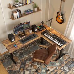 a computer desk with a keyboard, mouse and guitar