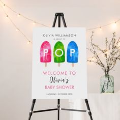 a welcome sign for a baby shower with pops on it