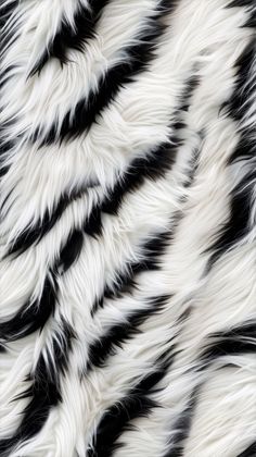 the black and white fur pattern is very unique to see in this image, it looks like an animal print