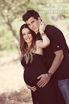 a pregnant couple standing next to each other in front of trees and grass with the caption canon rite photography