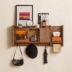 a wooden shelf with various items on it and a clock hanging from the wall behind it