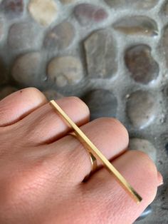 Minimalist Ring Simple Ring Geometric Ring Line Ring Minimal Ring Geometric Jewelry Looking for a cool ring that goes with everything?  This minimalist, gold bar ring features a 2" thin horizontal bar that spans across three fingers.   You will find yourself going back to this modern ring many times because it's easy to wear and makes a statement in an understated way.  Size 7, but you can vary the finger you wear it on!  *This ring comes ready for gift giving in a cute little pouch. Minimalist Rings Simple, Gold Bar Ring, Cool Ring, Mood Stone, Ring Minimal, Minimal Ring, Gold Color Ring, Bar Ring, Rainbow Jewelry