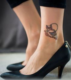 a woman's foot with an owl tattoo on her left ankle and black high heels