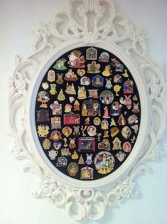 an ornate white frame with many different pictures on it