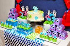 a table topped with lots of cakes and cupcakes