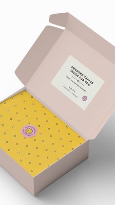 an open box with a yellow and pink design