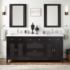 a bathroom vanity with two mirrors above it