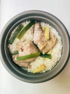 a bowl filled with rice and meat on top of a table