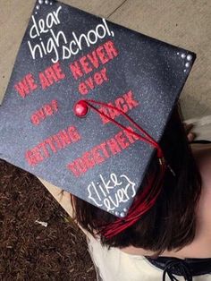 a woman wearing a graduation cap with writing on it