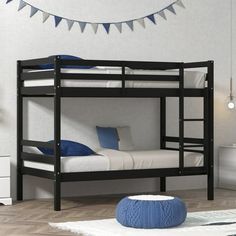 a black bunk bed sitting in a bedroom next to a white dresser and blue rug