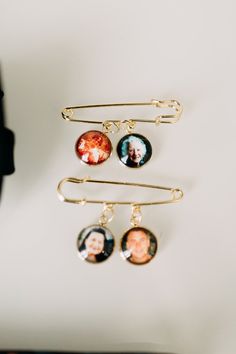 three hair pins with pictures hanging from them