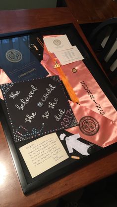 a wooden table topped with lots of different types of items and writing on it's side