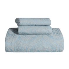 the blue sheets are folded on top of each other, and one has a flower pattern