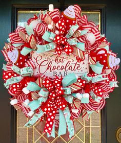 a red and white wreath that says hot chocolate bar on the front door with hearts