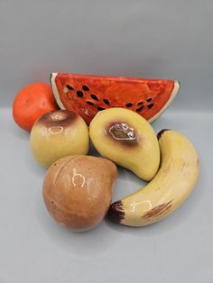 A collection of vintage-style ceramic fruits in various sizes, showcasing their aged patina and intricate detailing. Perfectly crafted to add a timeless aesthetic to any room. Fruit Decor, Christian Ornaments, Ceramic Fruit, Timeless Home, Kitchen Counters, Christian Decor, Unique Display, Bar Glassware, Light Switch Plates