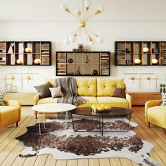 a living room with yellow couches and white tables in the center, surrounded by bookshelves