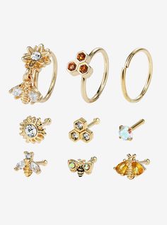 six pairs of rings with different designs and colors on the front, one is gold