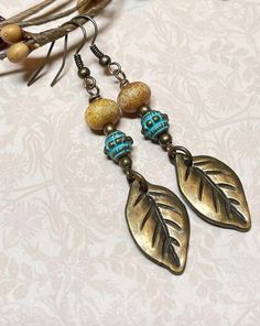 These bohemian style dangle earrings are a perfect fall accessory, but are also great for anytime of year!  These were created using antique bronze leaf charms, bronze green patina beads, tan Czech Picasso glass rondelles, and antique bronze nickel free ear wire.    Total length of earrings, including the ear wire, is approximately 2-1/2".  The bronze leaf charms measure approximately 1/2" wide x 1" long. Thank you for shopping with The Lucie Collection! Autumn Earrings, Bronze Green, Jewelry Making Earrings, Green Patina, Fall Earrings, Making Earrings, Earrings Bohemian, Earrings Beaded, Fall Accessories