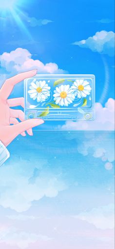 a person holding up a cell phone with daisies on the screen and clouds in the background