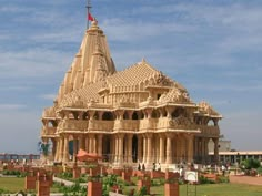 an elaborately carved building in the middle of a park