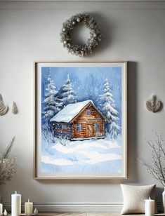 a painting of a cabin in the snow with wreaths on the wall above it