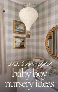 a baby boy nursery room with checkered wallpaper and pictures on the walls, including a round mirror