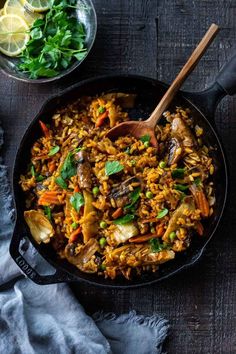 a skillet filled with rice and vegetables