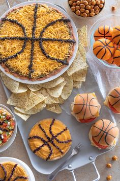 an assortment of snacks including cheese, crackers and basketballs are arranged on a platter