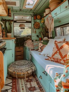 the interior of an old camper with lots of pillows and rugs on the floor